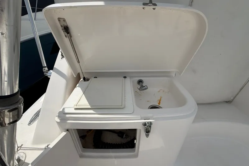 Slide: The Image of Open sink and storage area on a 2007 Cabo 32 Express boat. - 18