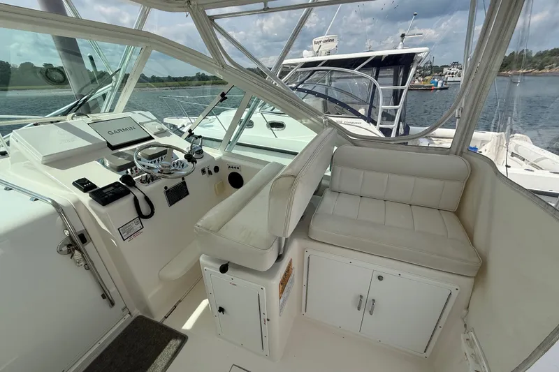 Slide: The Image of 2007 Cabo 32 Express boat cockpit with Garmin navigation system and comfortable seating. - 44