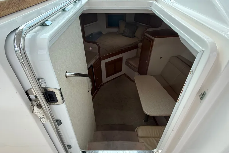 Slide: The Image of Interior cabin view of a 2007 Cabo 32 Express boat, featuring seating and a table. - 58