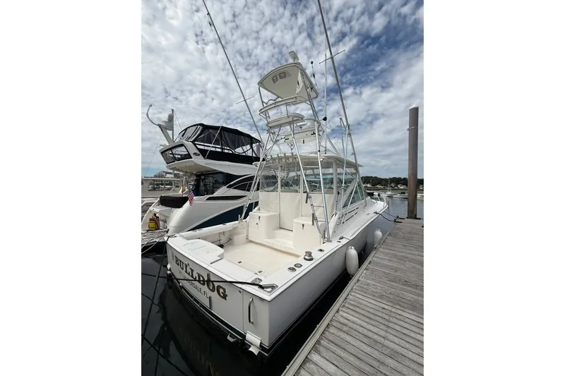 Slide: The Image of 2007 Cabo 32 Express boat docked at marina under cloudy sky. - 15