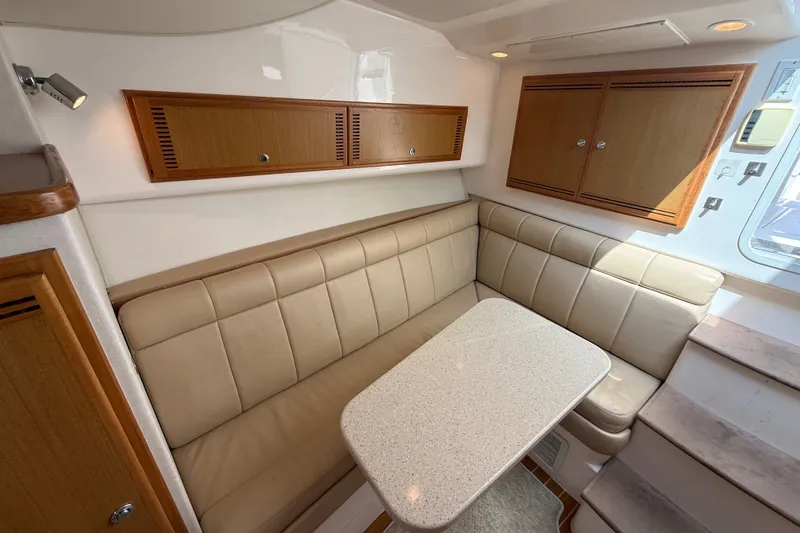 Slide: The Image of Interior of 2007 Cabo 32 Express yacht with beige seating and wooden cabinets. - 61