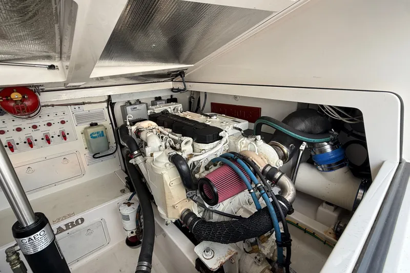 Slide: The Image of Engine room of a 2007 Cabo 32 Express boat, showcasing detailed machinery. - 31