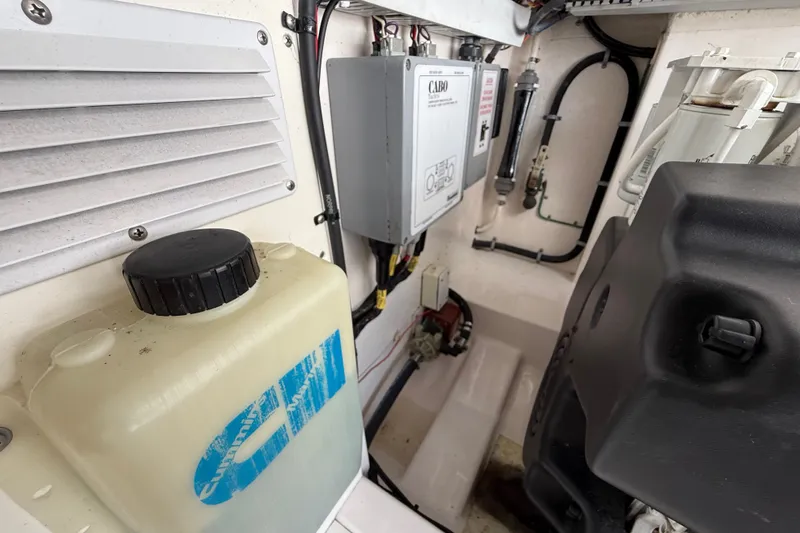 Slide: The Image of Engine compartment of a 2007 Cabo 32 Express boat, featuring various mechanical components. - 34