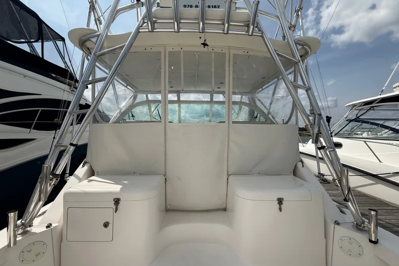 Slide: The Image of 2007 Cabo 32 Express boat with tower and seating, docked under a partly cloudy sky. - 17
