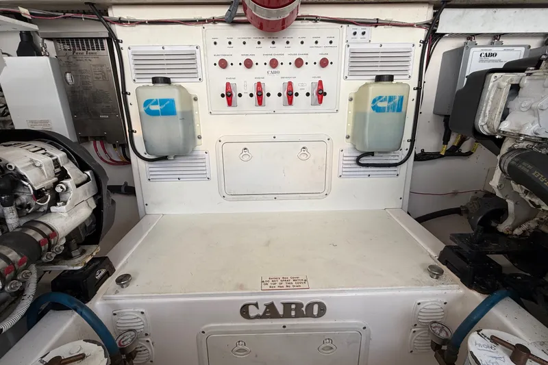 Slide: The Image of Engine room of a 2007 Cabo 32 Express boat, featuring control panels and equipment. - 32