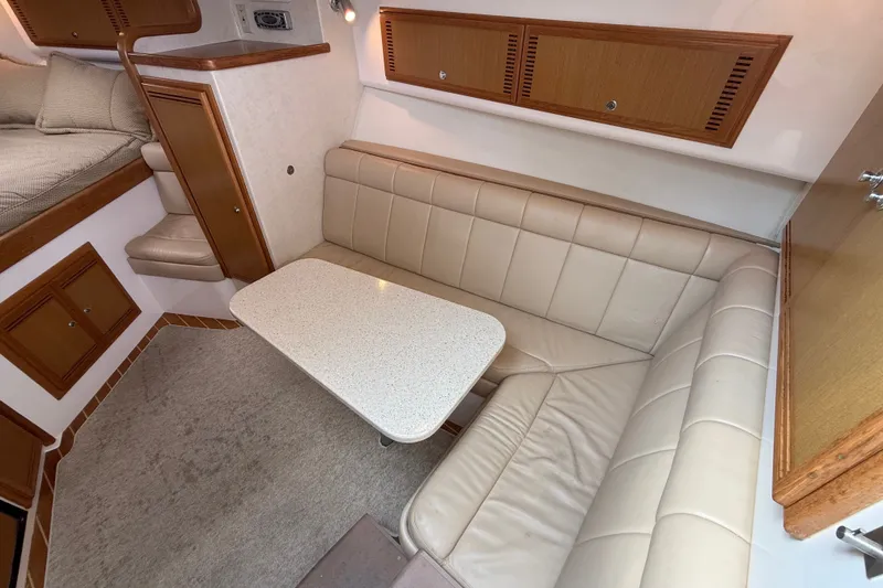 Slide: The Image of 2007 Cabo 32 Express interior with beige seating and a white table. - 60