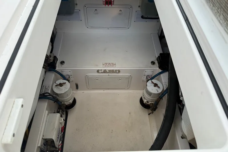 Slide: The Image of The engine compartment of a 2007 Cabo 32 Express with a clean, white surface and technical components. - 27