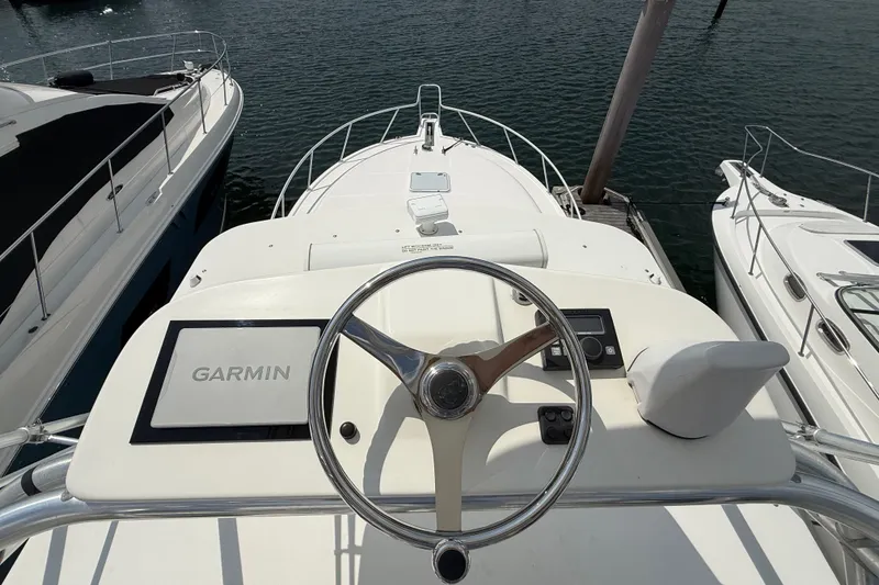 Slide: The Image of Helm of 2007 Cabo 32 Express boat with Garmin navigation system, docked between yachts. - 52