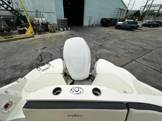 Slide: The Image of The image shows the stern of a 2021 Stingray 231 boat with an outboard motor. - 15