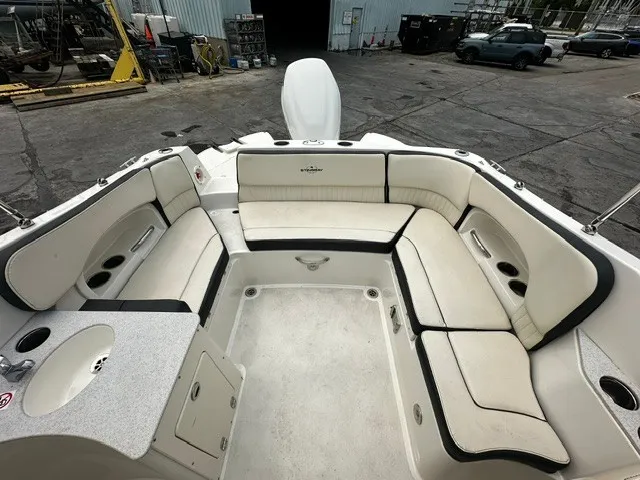 Slide: The Image of 2021 Stingray 231 with spacious cushioned seating area and built-in sink. - 14