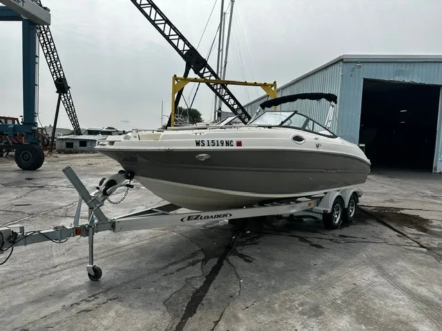 Slide: The Image of 2021 Stingray 231 on a trailer, in a shipyard area with cranes and a warehouse. - 23