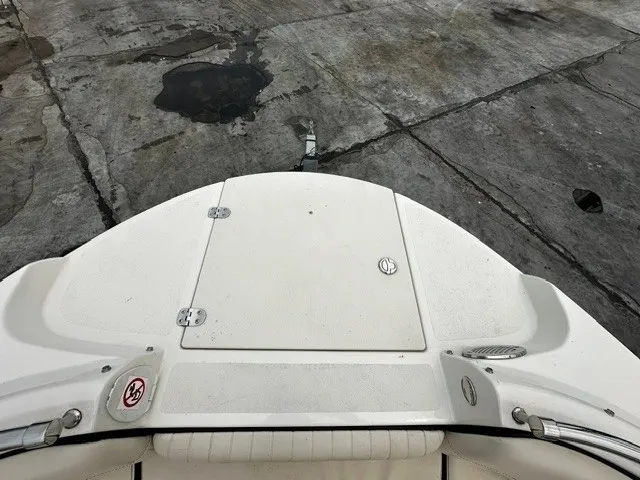 Slide: The Image of Boat's white deck with storage hatch, set on a concrete surface. - 11