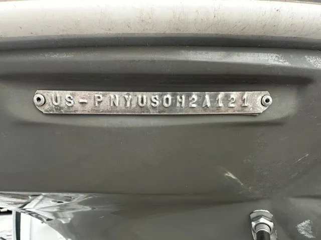 Slide: The Image of Close-up of a boat hull serial number on a gray background. - 4