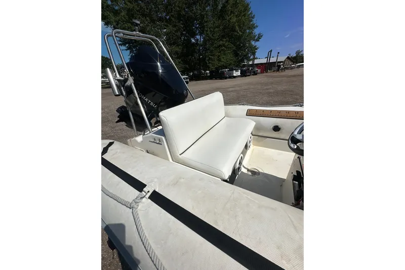 Slide: The Image of 1997 Zodiac Pro 420 boat interior with white seating and Tohatsu engine. - 11