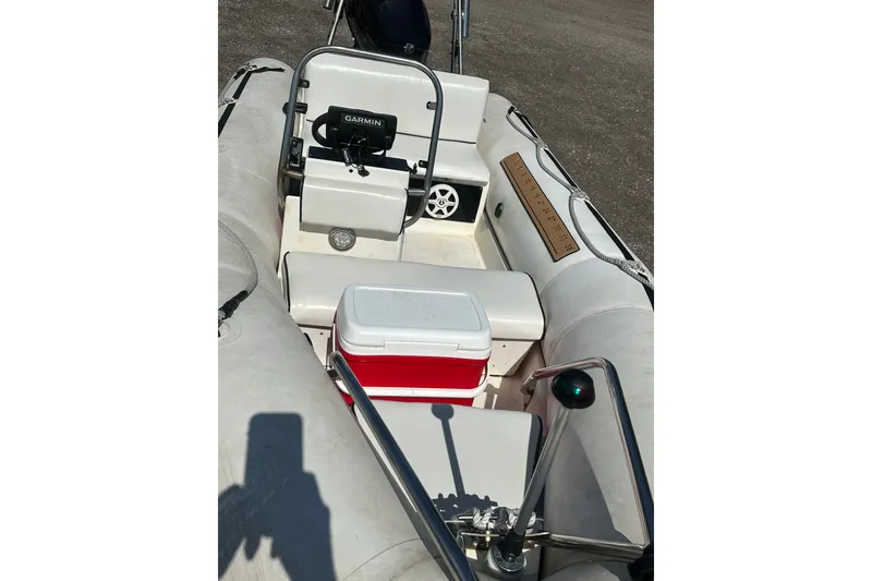 Slide: The Image of 1997 Zodiac Pro 420 boat interior with Garmin device and red cooler. - 10