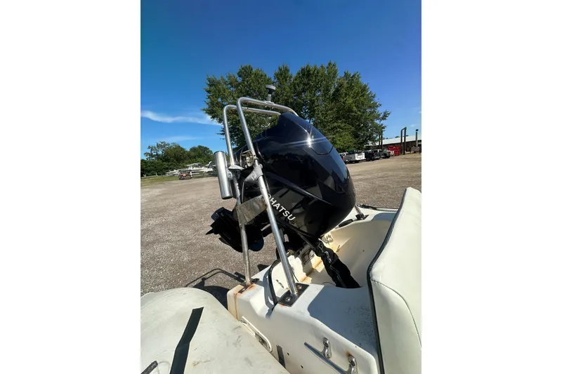 Slide: The Image of 1997 Zodiac Pro 420 boat with Tohatsu outboard motor in a sunny outdoor setting. - 14