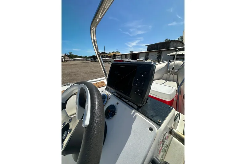 Slide: The Image of 1997 Zodiac Pro 420 boat dashboard with steering wheel and navigation equipment. - 13