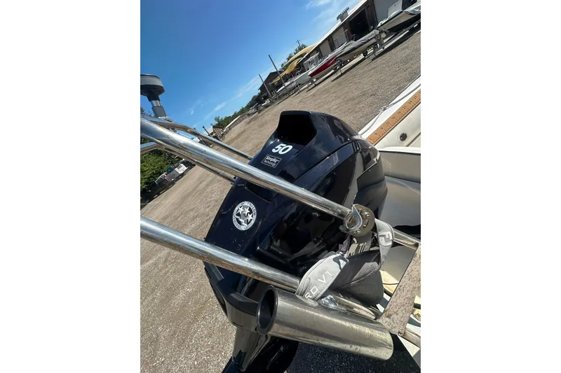 Slide: The Image of Outboard motor on a 1997 Zodiac Pro 420 boat, parked outdoors under a clear sky. - 15