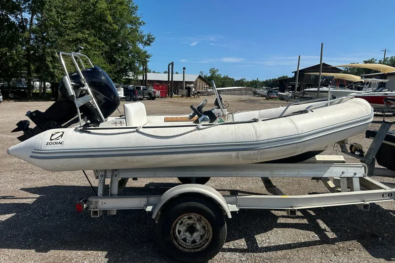 Slide: The Image of 1997 Zodiac Pro 420 inflatable boat on trailer, parked outdoors. - 8
