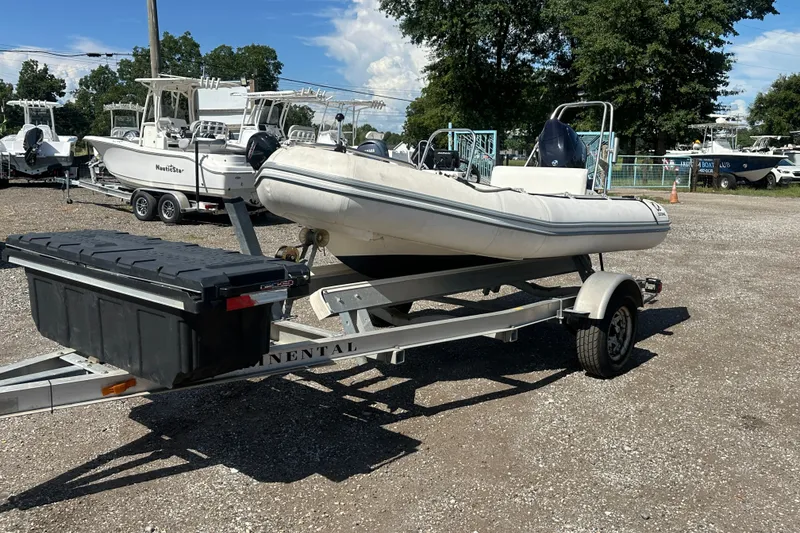 The Image of 1997 Zodiac Pro 420 inflatable boat on trailer in outdoor lot. - 1