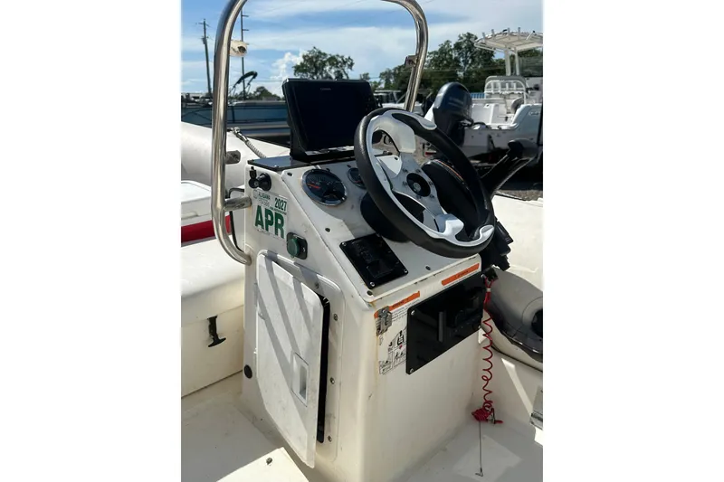 Slide: The Image of Control console of a 1997 Zodiac Pro 420 boat with steering wheel and gauges. - 17