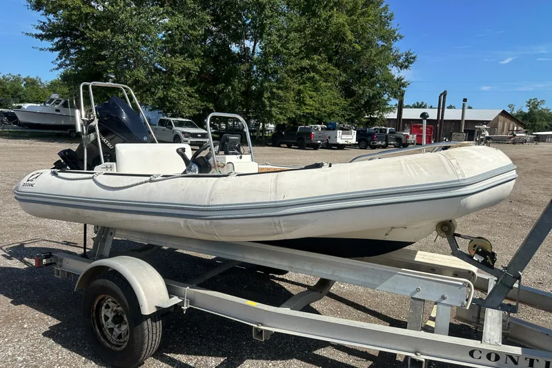 Slide: The Image of 1997 Zodiac Pro 420 inflatable boat on trailer in outdoor setting. - 9