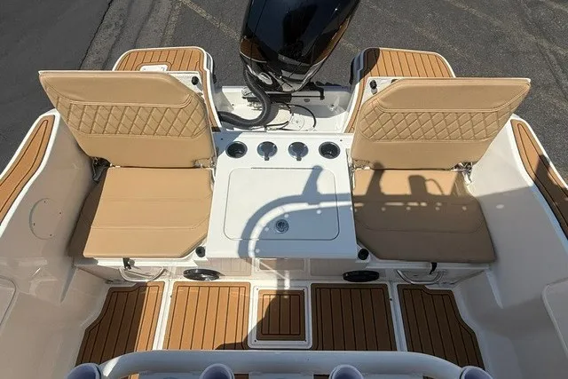 Slide: The Image of 2027 Bayliner Trophy T20CC boat interior with tan seating and wood-style flooring. - 14