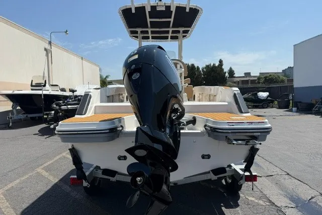 Slide: The Image of 2027 Bayliner Trophy T20CC boat with outboard motor, parked outdoors. - 20