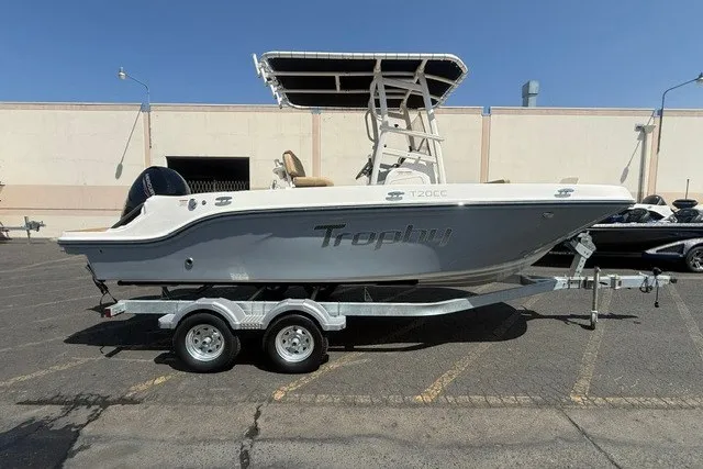 The Image of 2027 Bayliner Trophy T20CC boat on trailer, parked outdoors. - 0