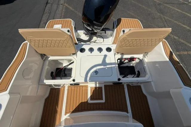 Slide: The Image of 2027 Bayliner Trophy T20CC boat deck with storage compartments and motor. - 16