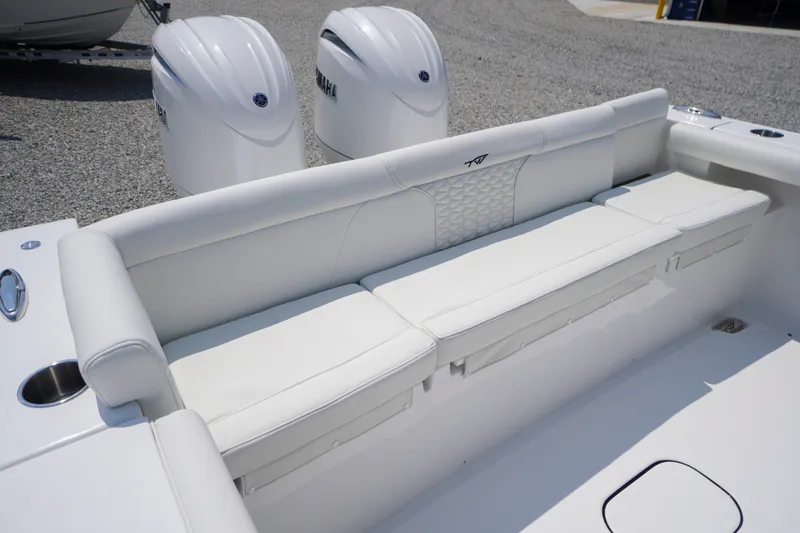 Slide: The Image of 2027 Tidewater 256 LXF boat with white seating and dual Yamaha engines. - 55