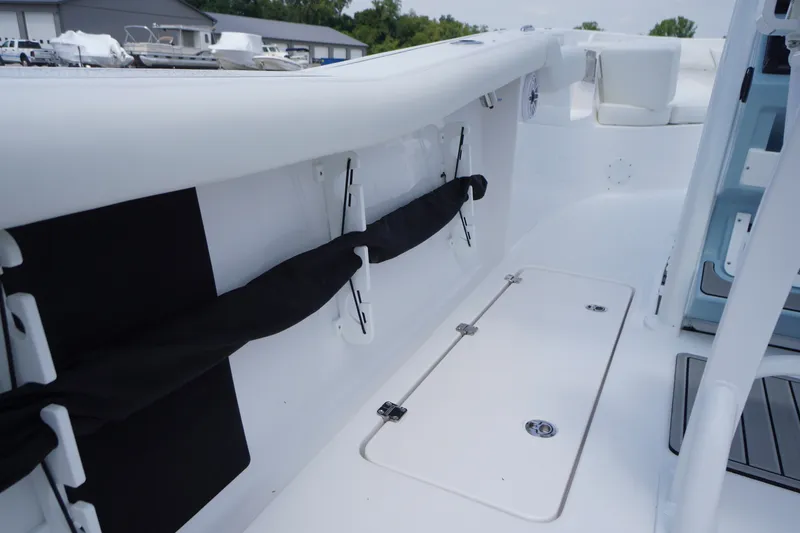 Slide: The Image of 2027 Tidewater 256 LXF boat interior with storage compartments and seating area. - 68