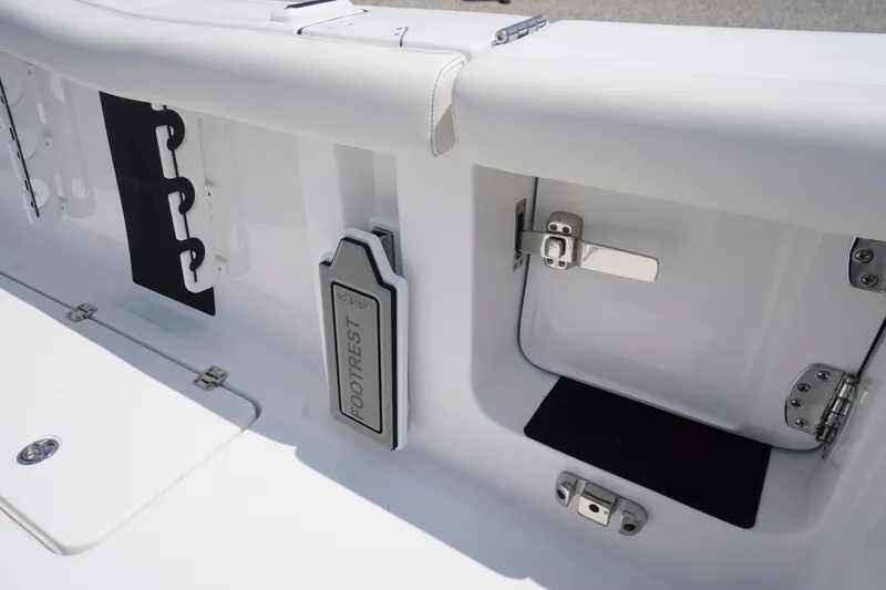 Slide: The Image of 2027 Tidewater 256 LXF boat interior with footrest and storage compartment. - 62