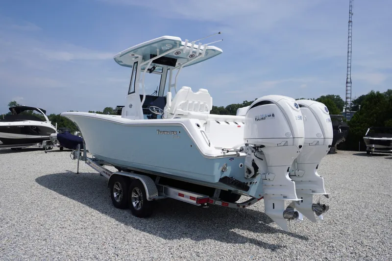 Slide: The Image of 2027 Tidewater 256 LXF boat with dual Yamaha engines on a trailer. - 81