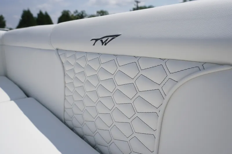 Slide: The Image of Luxurious white upholstery detail on 2027 Tidewater 256 LXF boat interior. - 56
