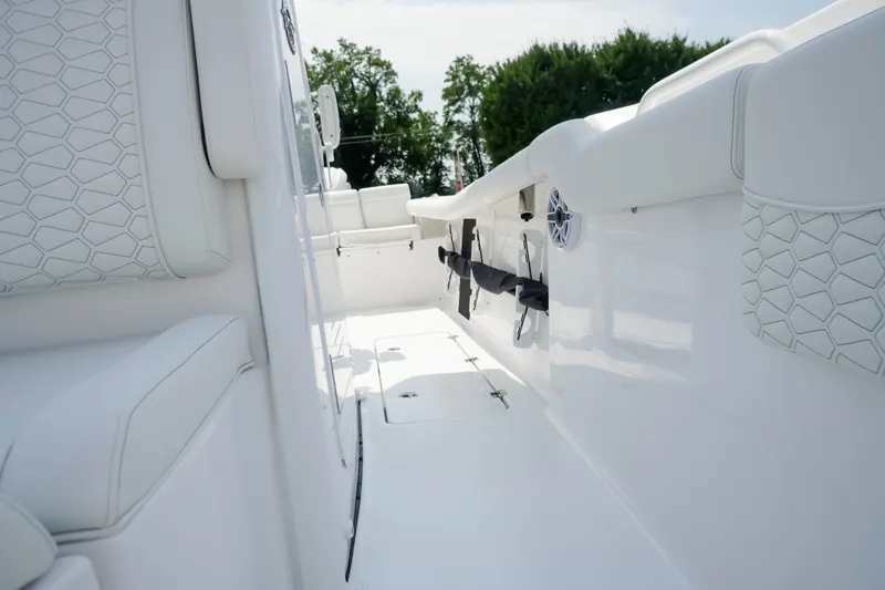 Slide: The Image of 2027 Tidewater 256 LXF boat interior with white seating and sleek design. - 22