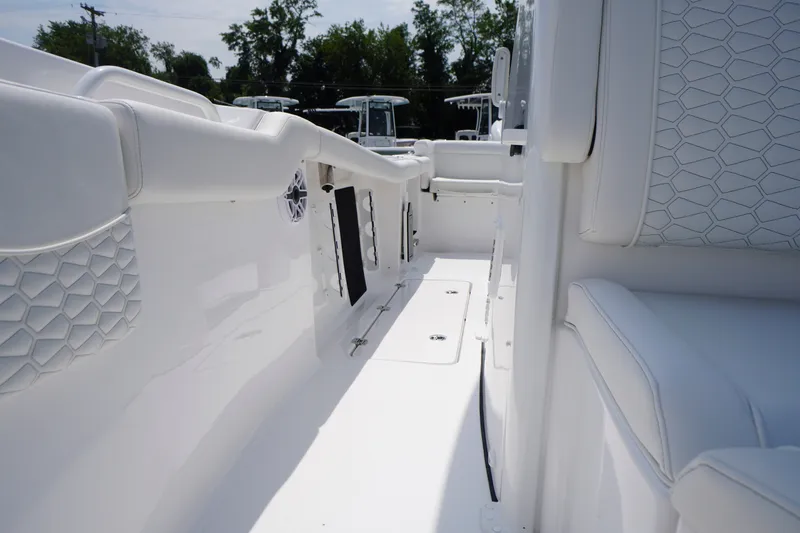 Slide: The Image of 2027 Tidewater 256 LXF boat interior with white seating and sleek design. - 23