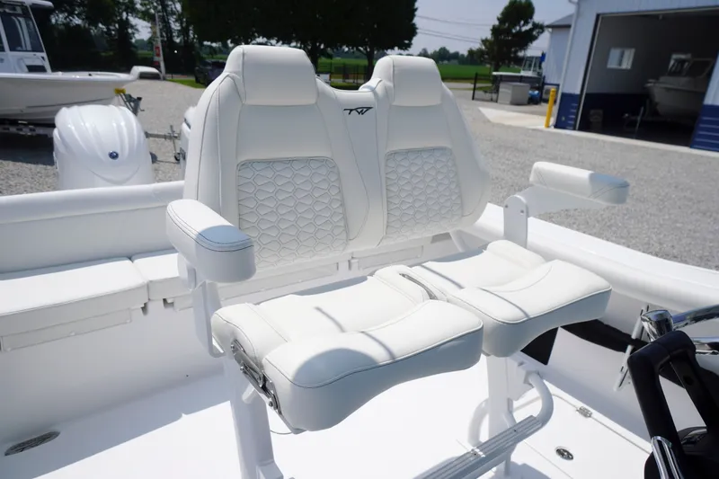 Slide: The Image of 2027 Tidewater 256 LXF boat with luxurious white seating and armrests. - 48