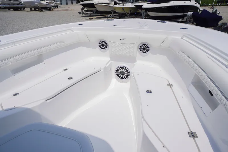 Slide: The Image of 2027 Tidewater 256 LXF boat interior with white seating and speakers. - 13