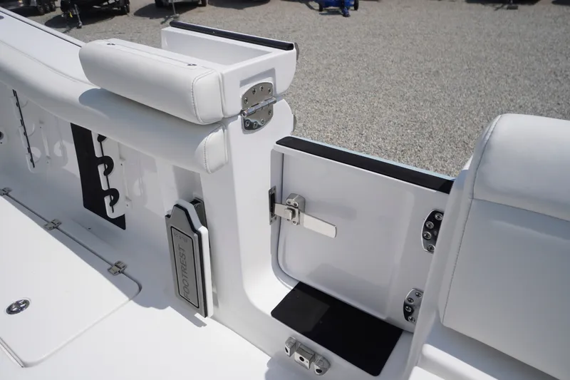Slide: The Image of 2027 Tidewater 256 LXF boat interior with white seating and secure latch. - 66