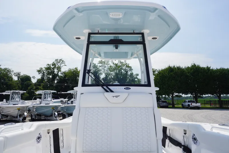Slide: The Image of 2027 Tidewater 256 LXF boat with sleek design and modern features, docked outdoors. - 19