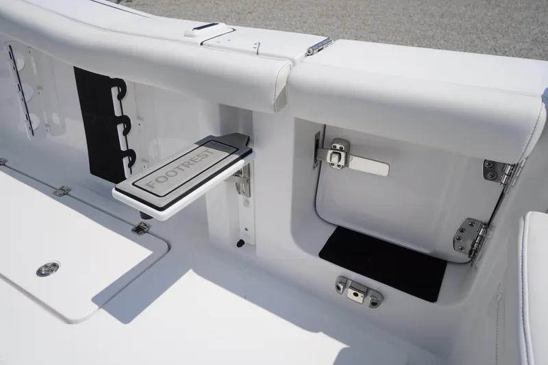 Slide: The Image of Tidewater 256 LXF 2027 boat interior with footrest and storage compartment. - 64