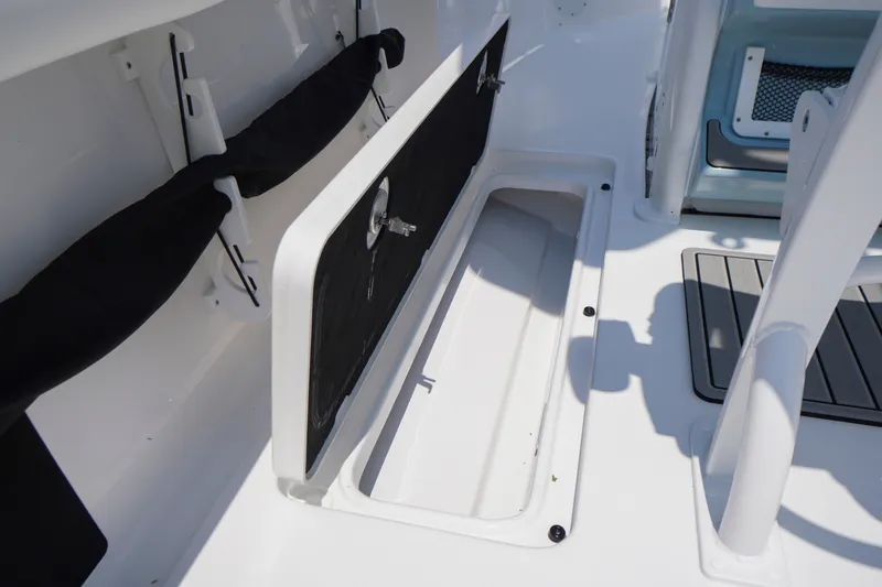 Slide: The Image of 2027 Tidewater 256 LXF boat storage compartment with open hatch and sleek interior design. - 54