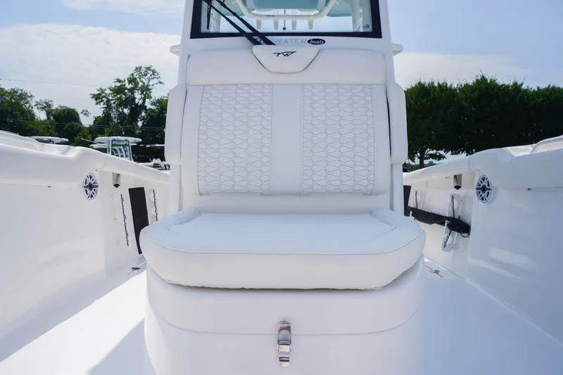 Slide: The Image of 2027 Tidewater 256 LXF boat interior with white cushioned seating and sleek design. - 20