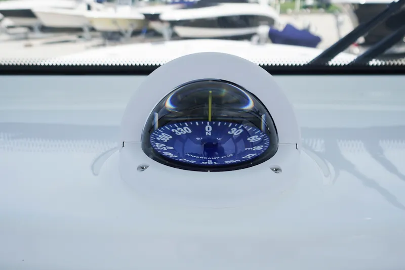 Slide: The Image of Compass on 2027 Tidewater 256 LXF boat dashboard, displaying navigation directions. - 40