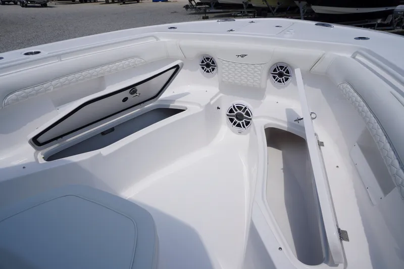 Slide: The Image of 2027 Tidewater 256 LXF boat interior with storage compartments and speakers. - 14
