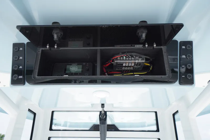 Slide: The Image of 2027 Tidewater 256 LXF boat console with electronic controls and wiring. - 42