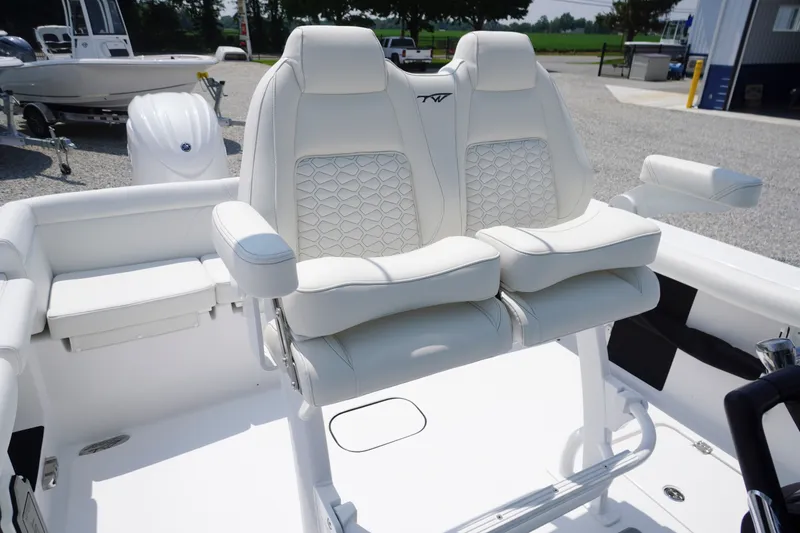 Slide: The Image of 2027 Tidewater 256 LXF boat with luxurious white seating and modern design. - 49