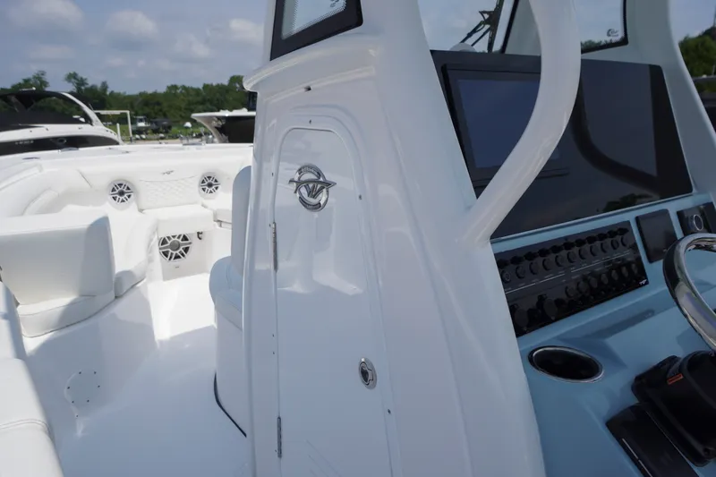 Slide: The Image of 2027 Tidewater 256 LXF boat interior with modern dashboard and seating. - 24