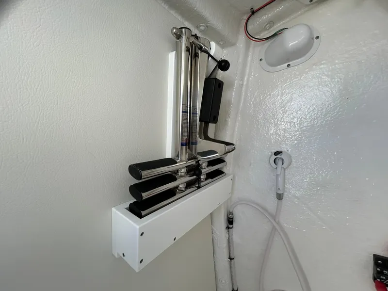 Slide: The Image of 2025 Tidewater 256 LXF boat interior with mounted fishing rod holders. - 28